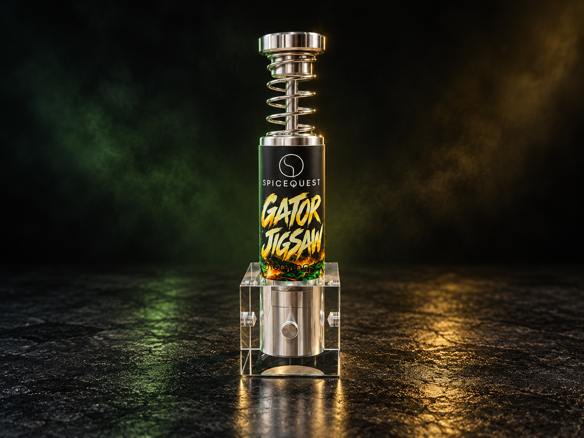 Gator Jigsaw SpiceQuest push-button grinder in its acrylic stand, dramatically lit in green and gold