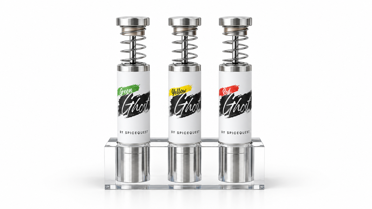 Green, Yellow, and Red Ghost pepper grinders with silver tips in a clear acrylic stand